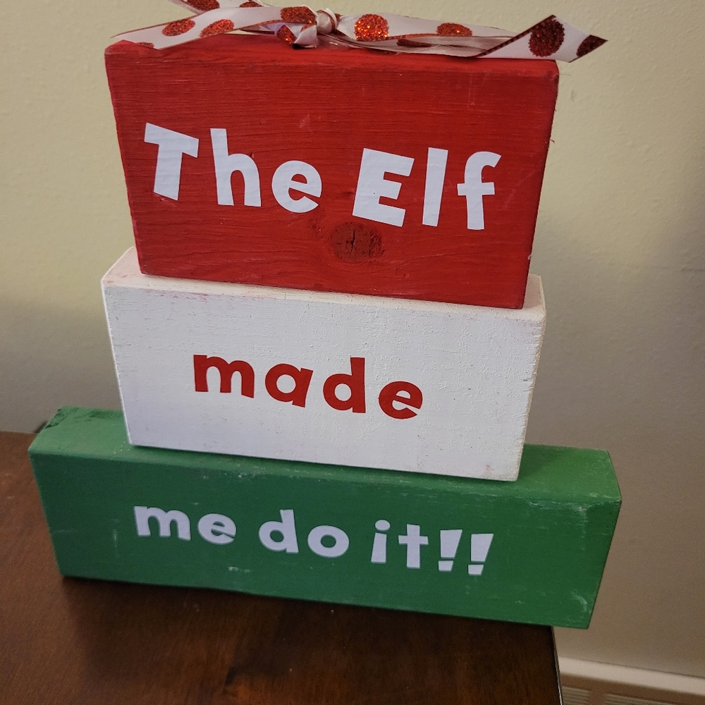 Beautiful Christmas decorative blocks that say "the Elf Made Me Do it" with a gl